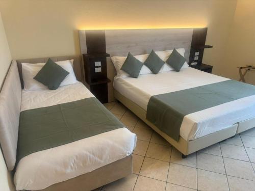 two beds in a hotel room with sidx sidx sidx sidx at Villa Cesi Resort & Spa in Impruneta