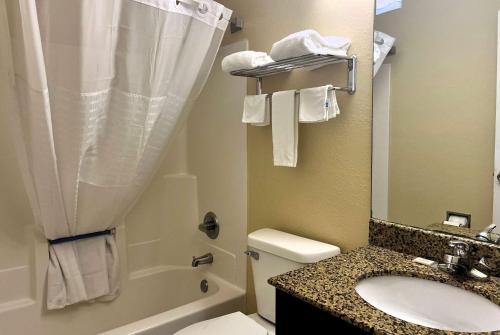 a bathroom with a sink and a toilet and a shower at Super 8 by Wyndham Indianapolis/NE/Castleton Area in Indianapolis