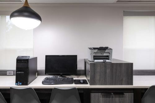 an office with a desk with a computer and a printer at Hyatt House Herndon/Reston in Herndon