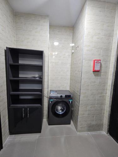 a bathroom with a washing machine in a room at Genesis Grid Homes - Ibiza Edition in Lagos