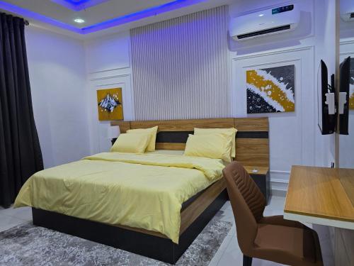 a bedroom with a bed and a desk and a chair at Genesis Grid Homes - Ibiza Edition in Lagos