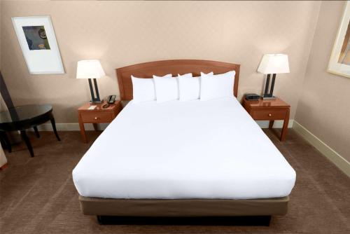 a bedroom with a large white bed with two night stands at Hilton Parc 55 San Francisco Union Square in San Francisco