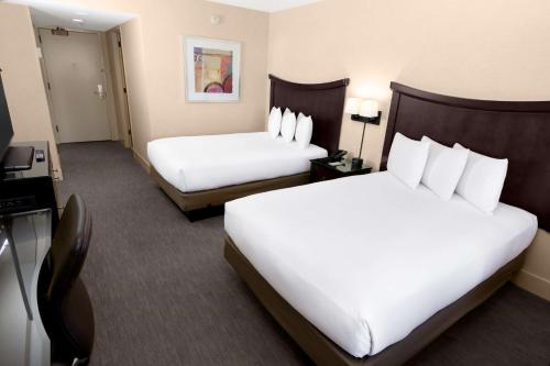 a hotel room with two beds and a television at Hilton Parc 55 San Francisco Union Square in San Francisco