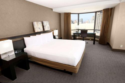 a hotel room with a large bed and a desk at Hilton Parc 55 San Francisco Union Square in San Francisco
