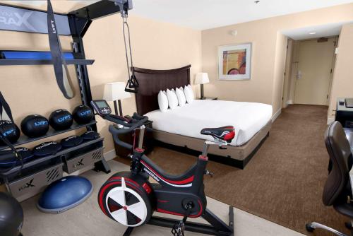 a hotel room with a bed and a gym at Hilton Parc 55 San Francisco Union Square in San Francisco