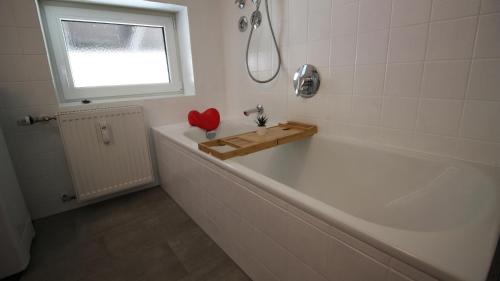 a bathroom with a tub with a red heart on it at FeWo Himmeleck, Oberstaufen/Wiedemannsdorf in Oberstaufen