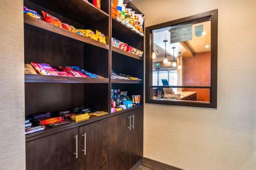 a food pantry with wooden shelves and a mirror at Best Western Plus Kindersley Hotel in Kindersley