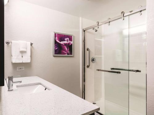 a bathroom with a sink and a shower at La Quinta Inn & Suites by Wyndham San Antonio Downtown in San Antonio
