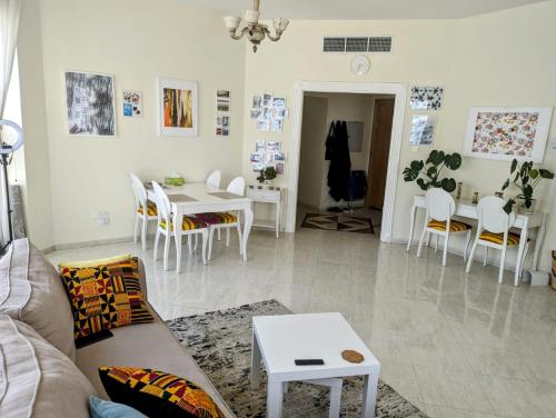 a living room with a couch and a table at Home stay - FEMALE GUEST ONLY -ممنوع دخول الرجال in Sharjah