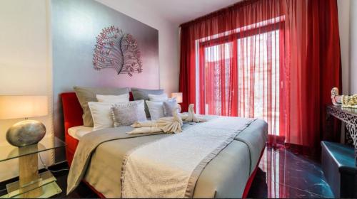 a bedroom with a bed with red curtains and a window at Villa-Galeria-Verde-in-Betlem in Colonia de Sant Pere