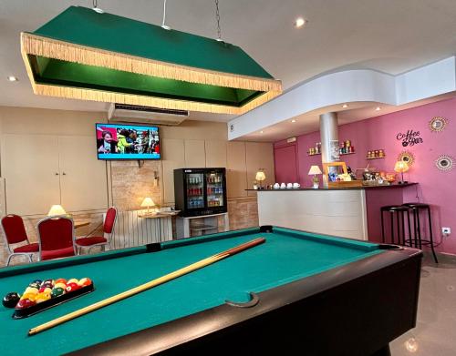 a pool table in a billiard room with a bar at Hotel Piccadilly Sitges in Sitges