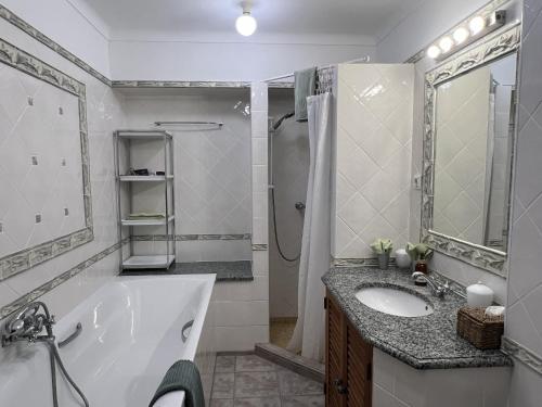 un bagno con vasca, lavandino e doccia di 233 Galo Verde Apartment, 2 Schlafzimmer a Benagil