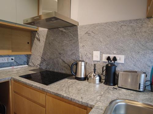 a kitchen with a sink and a counter top at Bokkombaai in Bloubergstrand