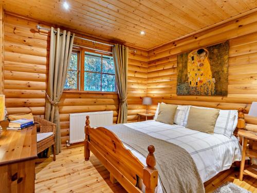 Un dormitorio con una cama en una cabaña de troncos en 3 Bed in Peebles LK15M, en Walston