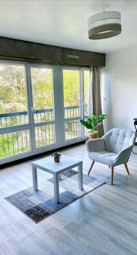 a living room with a couch and a coffee table at Beau studio haut standing de 30m2 in Montreuil