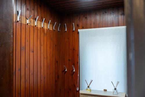 a wall with knives on a wooden wall at Rockvale Cottage in Fort William