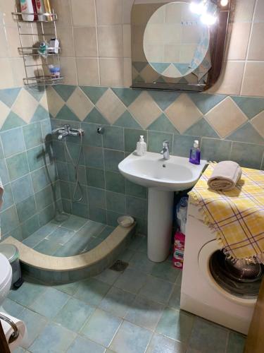 a bathroom with a sink and a shower and a toilet at Traditional House with breathtaking view, Makis in Sívros