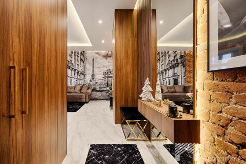 a hallway with a living room with a fireplace at Premium Glamour by LookAp in Łódź
