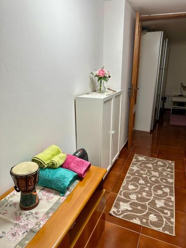 a room with a table with colorful pillows on it at Casa Palumbo in Bacoli
