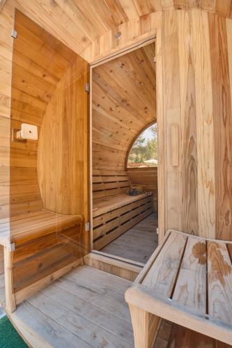 a wooden sauna with a bench in the middle at Villa B&M Experience in Sant Francesc de s'Estany