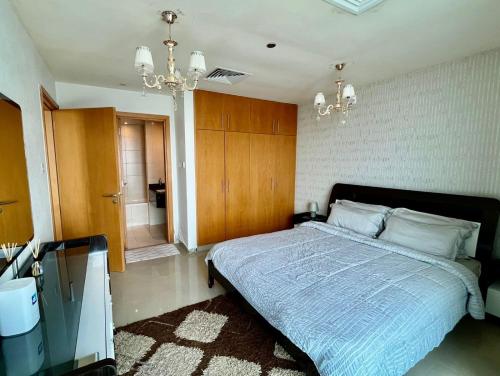 a bedroom with a large bed and a bathroom at Luxury 1BR Uninterrupted Sea View, Fully Equipped in Ras al Khaimah