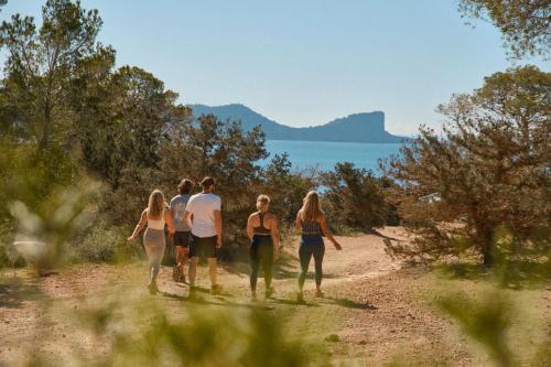 a group of people walking down a dirt road at Villa B&M Experience in Sant Francesc de s'Estany