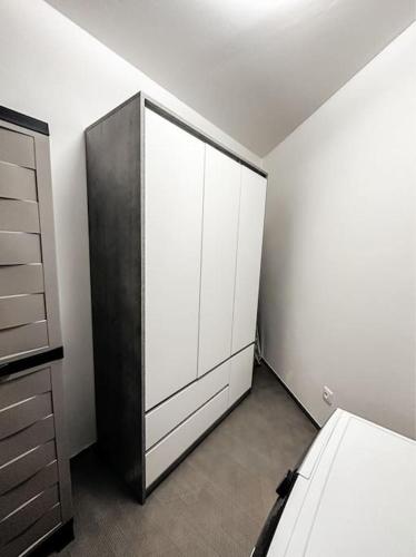 a bedroom with white cabinets and a black cabinet at Studio K2 in Brno