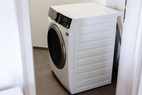 a white washer and dryer in a room at Studio K2 in Brno