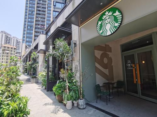 a restaurant with plants on the side of a building at Interact China Fine Condo - Shenzhen Bay in Shenzhen