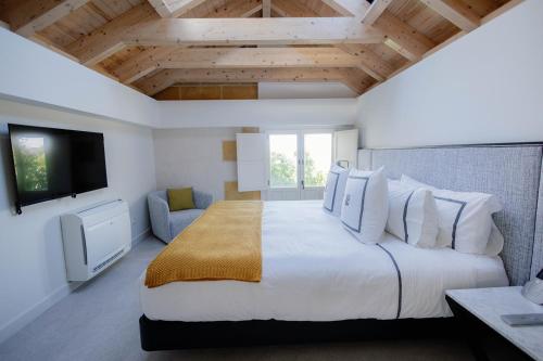 a bedroom with a large bed and a tv at La Fonda Heritage Hotel Luxury, Relais & Châteaux in Marbella