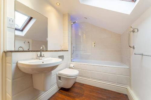 a bathroom with a sink and a toilet and a shower at Mill Top in Ambleside