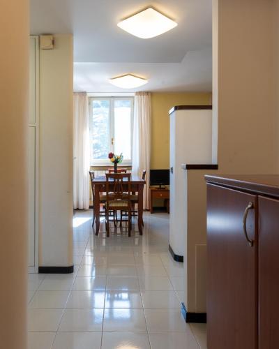 a kitchen and dining room with a table and chairs at Hotel Terme in Sarnano