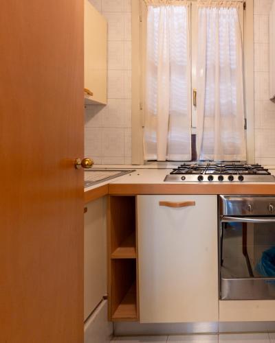 a kitchen with a stove top oven next to a window at Hotel Terme in Sarnano