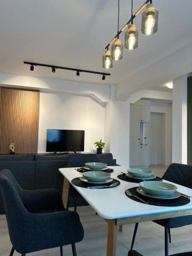 a dining room with a table with plates on it at BinderHaus 26 in Sibiu