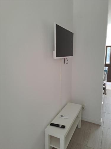 a white room with a tv on a white wall at apartamento perto do Santuário in Fátima