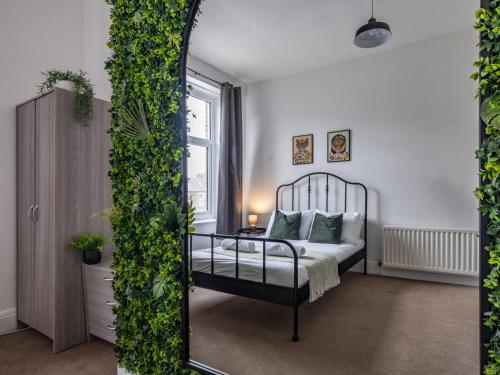 a bedroom with a bed and a mirror at Large Group Central Apartment in Newcastle upon Tyne