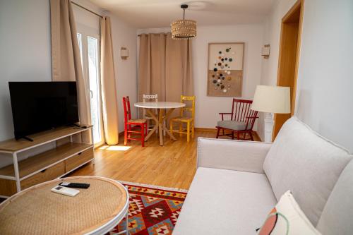 a living room with a couch and a tv and a table at TURISALENTEJO - ATIVIDADES TURÍSTICAS, LDA in Redondo