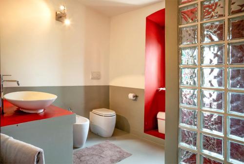 a bathroom with a sink and a toilet at Proprietà Scalfati in Sabaudia