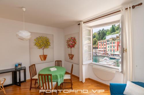 ein Wohnzimmer mit einem Tisch und einem Fenster in der Unterkunft Your Window on Portofino by PortofinoVip in Portofino