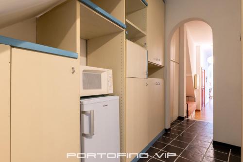 a kitchen with a refrigerator and a microwave at Your Window on Portofino by PortofinoVip in Portofino