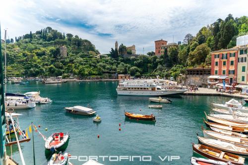 a group of boats are docked in a harbor at Your Window on Portofino by PortofinoVip in Portofino