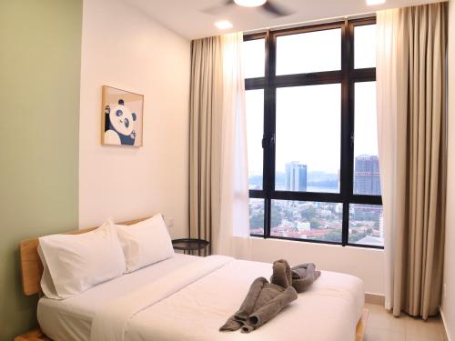 a bedroom with two beds and a large window at Twin Tower Residence by Nest Home【5 mins walk to CIQ】 in Johor Bahru