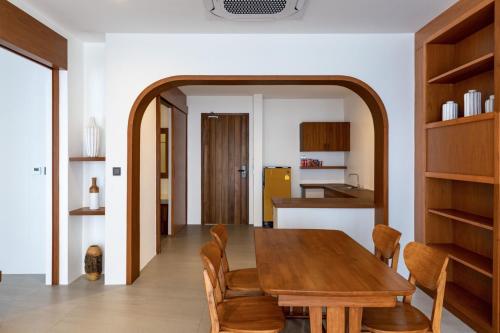 a dining room with a wooden table and chairs at X-Sea Khanom Harbor Bay Resort in Khanom