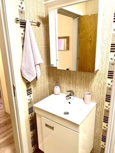 a bathroom with a white sink and a mirror at Апартамент Франческа in Varna City