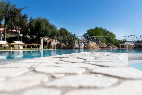 a large swimming pool with a water park at Luxury Home in Porto Rotondo in Cugnana