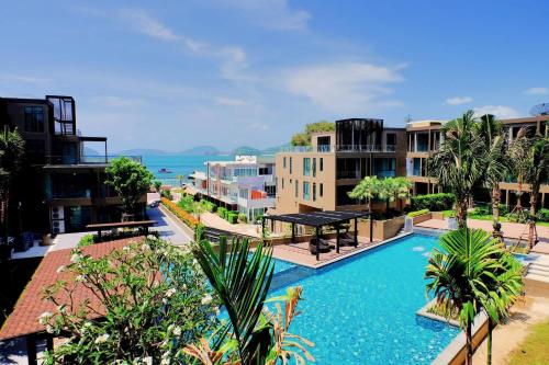 an apartment complex with a swimming pool and buildings at Seaview At Cape Panwa in Panwa Beach
