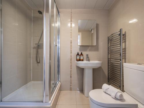 a bathroom with a shower and a toilet and a sink at Spacious City Sanctuary in Newcastle upon Tyne