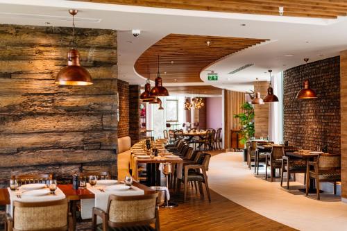 a restaurant with tables and chairs and a brick wall at Concorde Tower Hotel & Casino in North Nicosia
