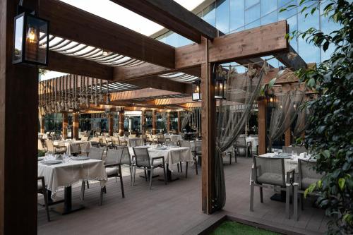 a restaurant with tables and chairs on a deck at Concorde Tower Hotel & Casino in North Nicosia