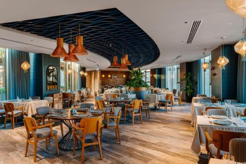 a restaurant with tables and chairs and lights at Concorde Tower Hotel & Casino in North Nicosia